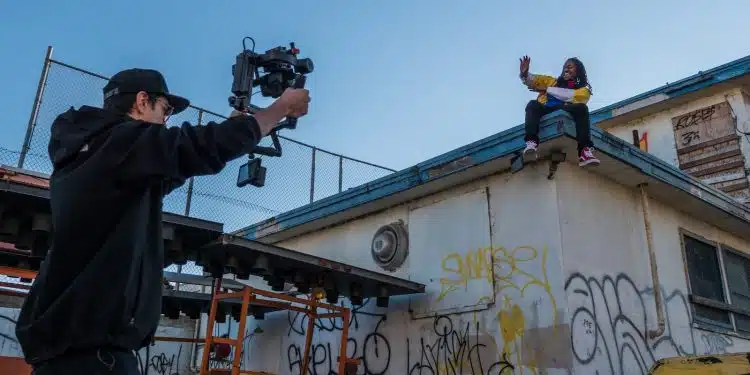 man taking a video of a person on roof